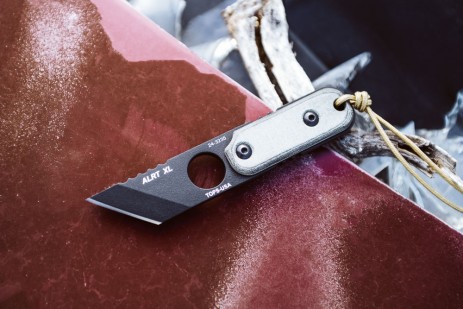 TOPS ALRT XL 03 compact fixed blade knife featuring a black utility blade with a durable angular tip and black canvas micarta handles.