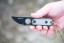 TOPS ALRT XL-05 compact fixed blade knife featuring a black hunter's point blade shape and black canvas micarta handles.