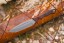 Viking Tactics Norseman knife with tan and green Micarta handle featuring blood red liners and Tungsten Cerakote blade.